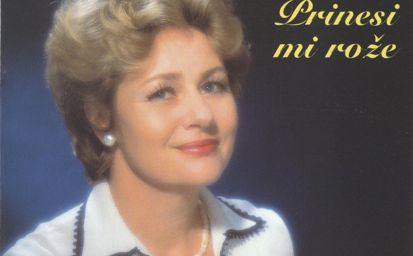 Zunanja platnica albuma Stanke Kovačič - Prinesi mi rože. Pevka v beli bluzi ima svežo trajno in z nasmehom gleda v objektiv.