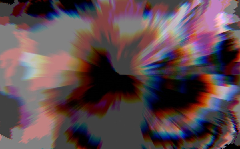 A friendly-looking squirrel with a bushy tail perched attentively on a wooden fence in natural outdoor surroundings